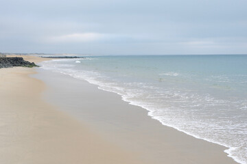 Empty ocean beach landscape of faded calm colours in France