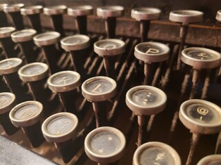 Closeup business and office themed studio shot of the typing keys of an antique typewriter.