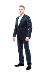Confidence and charisma. Full length of young businessman in suit keeping arms crossed and looking...