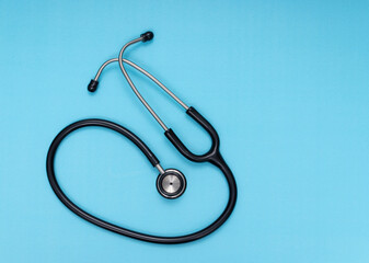 black stethoscope, blue isolated background