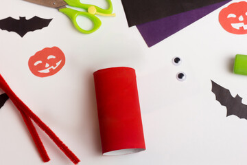 Step by step photo instruction Halloween craft. Step 1 Handmade decoration monster from toilet paper roll. Reuse concept