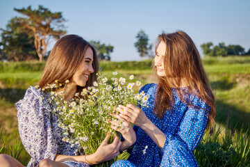 two girls with a bouquet of flowers