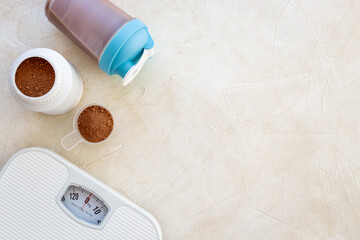 Sport diet food - whey protein in jar and scales. Fitness and gym concept