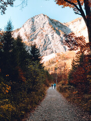 Two people walking towards the mountain