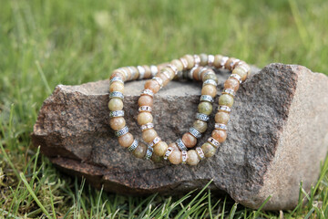 Two bracelets made of natural jasper stones beads. Handmade jewelry. Woman exoteric accessories. Talismans and amulets. Selective focus