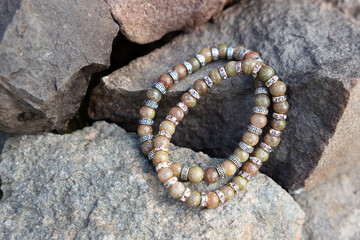 Two bracelets made of natural jasper stones beads. Handmade jewelry. Woman exoteric accessories. Talismans and amulets. Selective focus