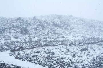 Blizzard, mist and snowfall in the mountains, poor visibility, winter bad weather