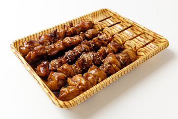Teriyaki chicken skewers on a white background