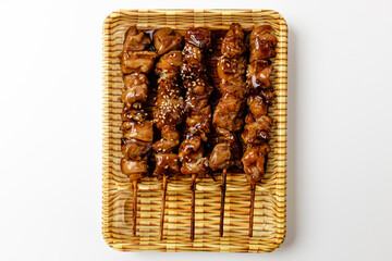 Teriyaki chicken skewers on a white background