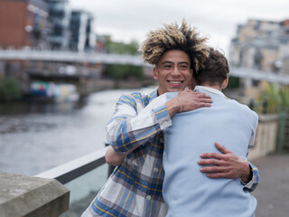 Young men hugging