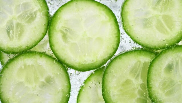 Slices of Cucumber in Water with Bubbles, Home Made Lemonade. Super Slow Motion, Filmed on High Speed Cinematic Camera at 1000 fps.