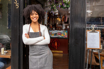 UK, London, Portrait of smiling cafe owner at doorway