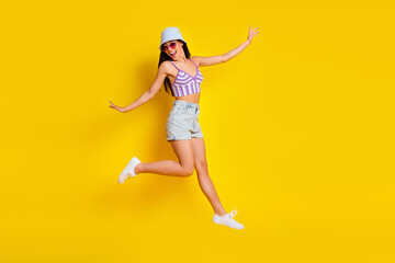 Fototapeta na wymiar Full length image of energetic cheerful girl go crazy at pool party weekend wear knitted bikini isolated on yellow color background