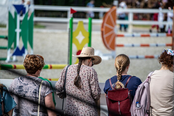 spectators at the equestrian festival and watching with interest what is happening