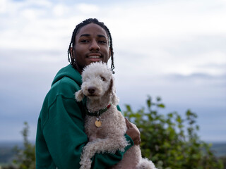 Portrait of teenage (16-17) boy holding dog