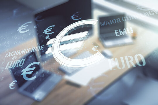 Creative concept of EURO symbols illustration and modern desktop with computer on background. Trading and currency concept. Multiexposure