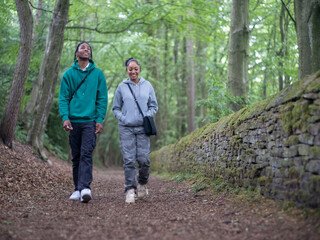 Teenage (16-17) girl and boy in forest