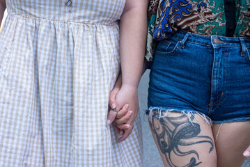 Close-up of lesbian couple holding hands