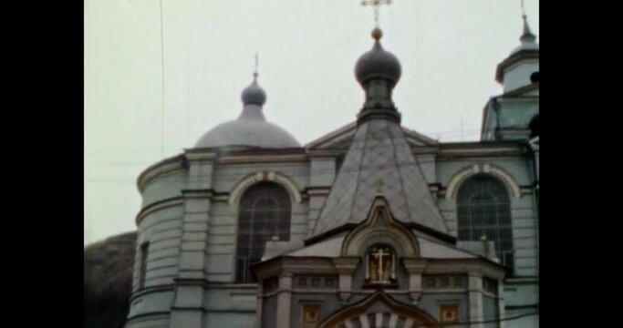 Ancient Christian church. Panoma wooden old church Holy Cross Church with parishioners. Orthodox cathedral religion temple architecture. Vintage color film. Retro archive. 1980s winter Kyiv, Ukraine 