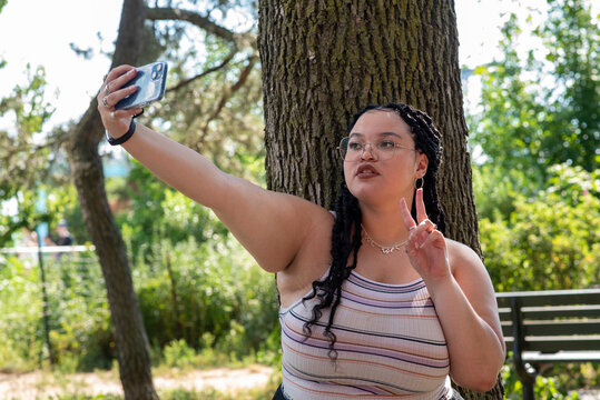 Young woman taking selfie in park