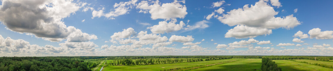 Fototapeta na wymiar Blue sky panorama with clouds over tops of green trees. Blue sky and white cloud soft. White clouds background.