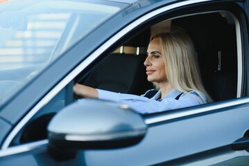 Fototapeta na wymiar Businesswoman sitting in drivers seat in her car