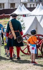 a man dressed as a 17th century soldier doing ordinary soldier work at a historical festival