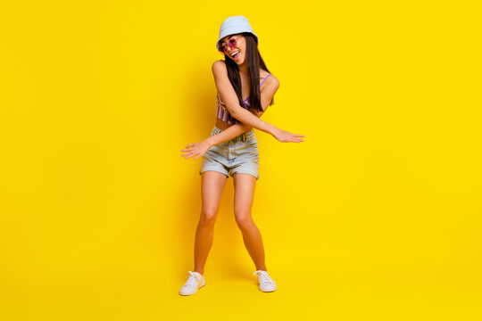 Full body image of active positive female have fun dancing near pool beach holiday party isolated on yellow color background