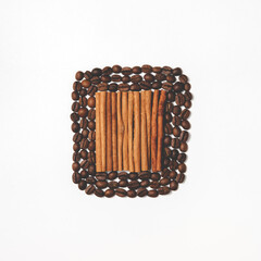 Composition of cinnamon sticks and coffee beans in flat lay. The concept in culinary style, the preparation of fragrant namitki and pastries. Top view in square orientation.
