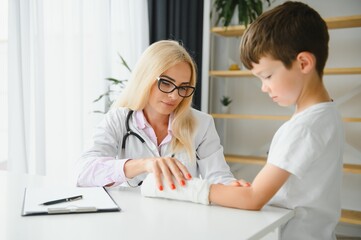 Fototapeta premium A child with a plaster on his hand at clinic