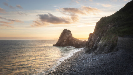 Sunrise over rocky coastline