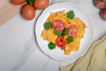 Oil-free tomato omelette in a white plate. Healthy food ideas for weight loss.