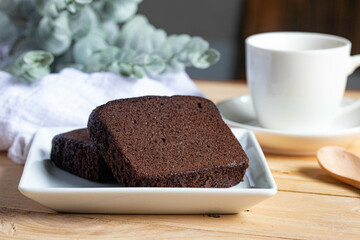 Chocolate cake with coffee in a white plate
