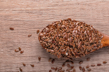 Flax seeds in a wooden spoon. Healthy whole grain food.