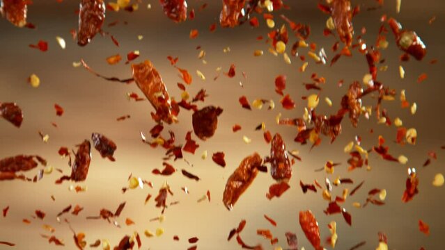 Falling of dry chilli peppers, close-up, macro shot. Filmed on high speed cinematic camera at 1000 fps.