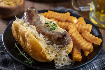 Grilled bratwurst and sauerkraut on a bun