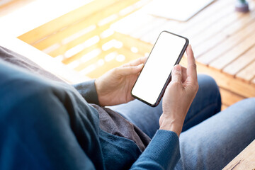 cell phone blank white screen mockup.hand holding texting using mobile on desk at office.background empty space for advertise.work people contact marketing business,technology