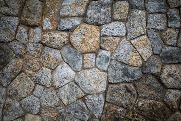 Background texture of Rough stone wall, Stone cladding, Old castle stone wall, Grey, brown Color, Close up shot
