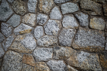 Background texture of Rough stone wall, Stone cladding, Old castle stone wall, Grey, brown Color, Close up shot