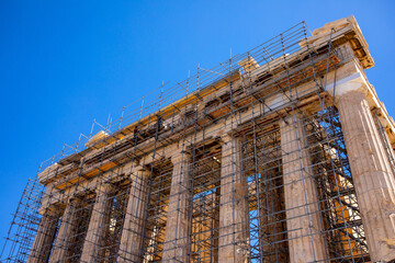 Renovation of the acropolis in Athens. View of the facade and columns of the Acropolis in Athens which are being restored by workers. Greece, July 2022.