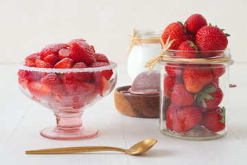 Fresh strawberries with creme fraiche, tasty fruit dessert, copy space, no people, low angle closeup.