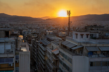 View of Athens with sunset and smoke. General view of the city with sunset and fire smoke in the background. Greece, July 2022.