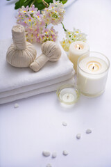 Fototapeta na wymiar Spa setting with, herbal ball, ,candle , herbal ,ball, white stones and towel, orchid 