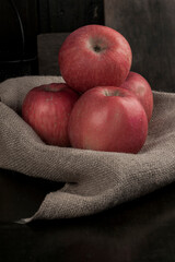 Close-up of apples on wooden tray with burlap base
