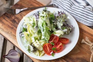 Side salad with lettuce and tomatoes on a plate