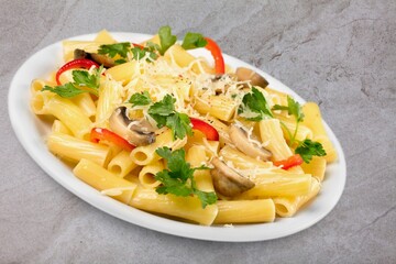 Tasty noodles dish on the plate on the desk.