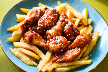 crispy barbecue chicken wings with fries