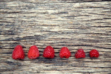Fresh organic red raspberries. Composition with non-gmo red raspberries on the table. The concept of health, non-gmo products, clean ecological food.