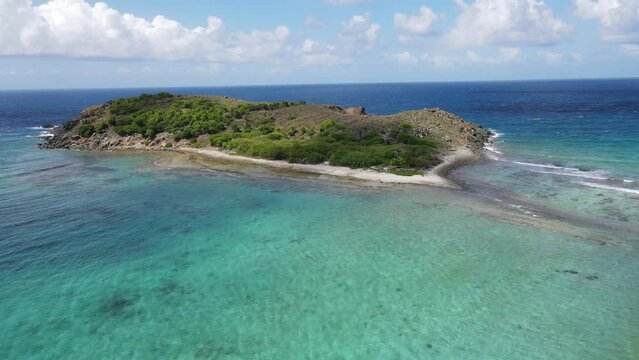 Deserted sandy Caribbean island in the the BVI's surrounded by blue water