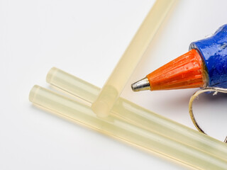 close up of the nozzle of an electric powered Hot Glue Gun  with  rods  sticks